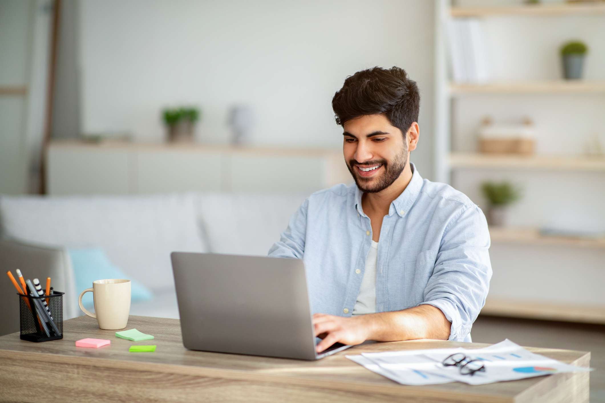 A man uses a laptop.